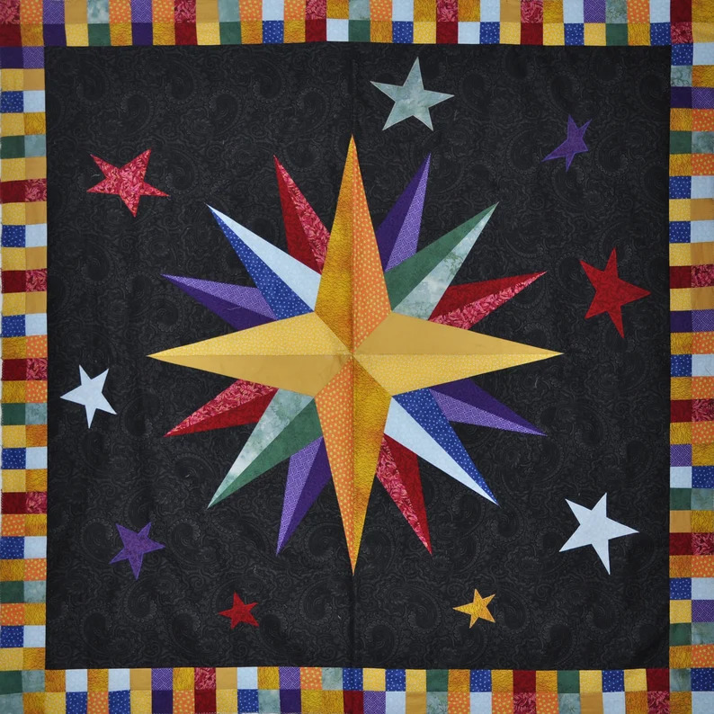 Patchwork quilt with rainbow starburst center and star motifs on dark fabric with multicolored striped border