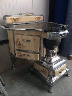 Antique Victorian-style cook stove with decorative trim indoors