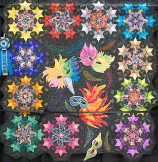 Colorful patchwork quilt with star patterns and masquerade masks on dark background