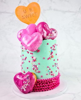 Mint green layered cake with pink heart balloons and U R Sweet topper