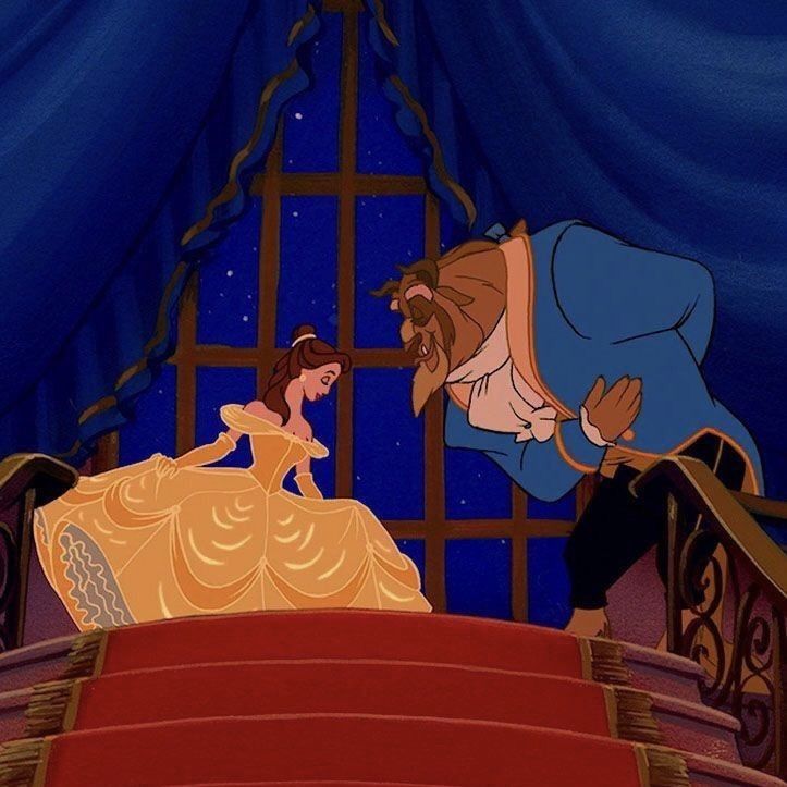 Belle and the Beast bowing on a staircase in a blue ballroom