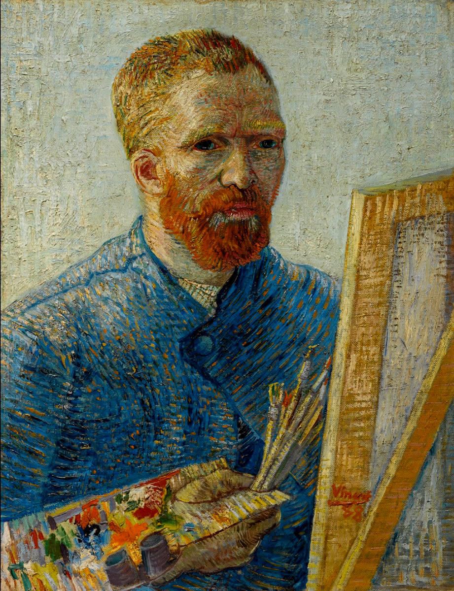 Painter holding brushes and palette while working on a canvas