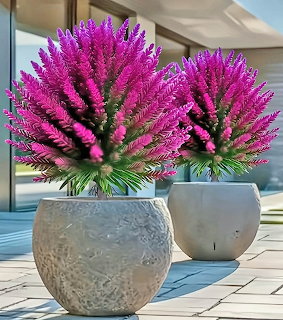 Bright purple artificial plants in two round gray stone pots on a modern outdoor patio