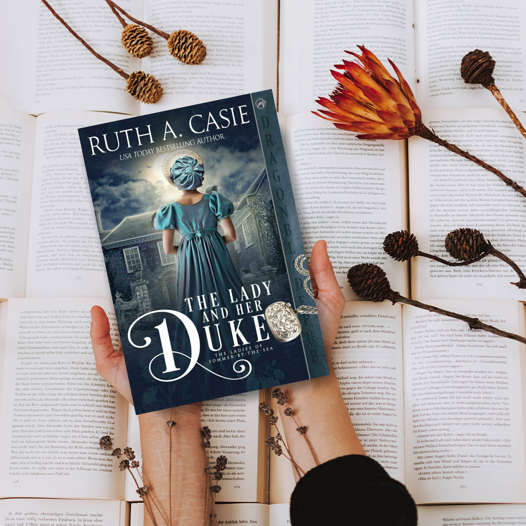 Hands holding The Lady and Her Duke book over open pages with dried flowers