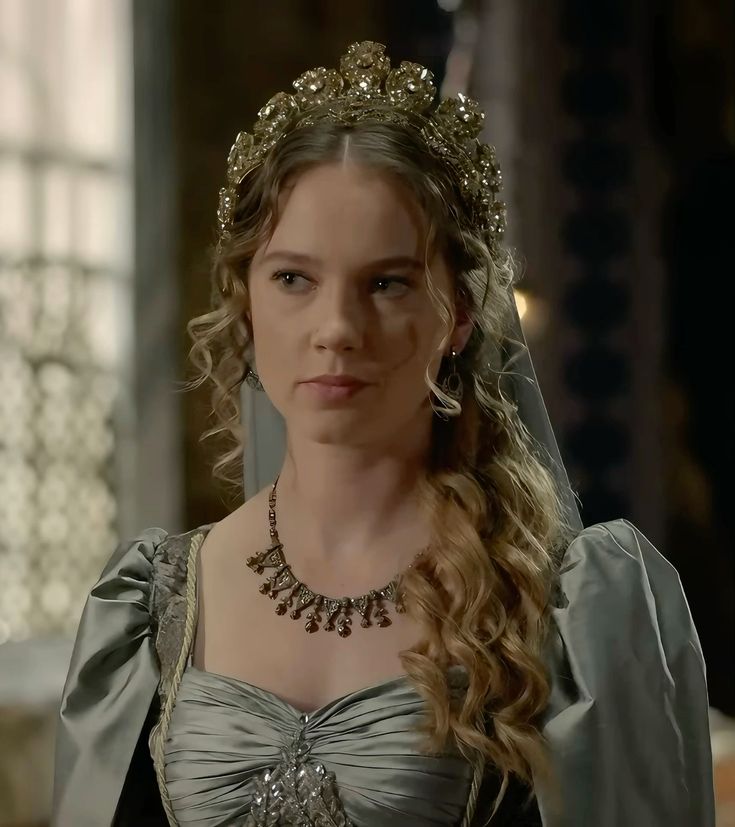 Young woman wearing a tiara and historical dress in an indoor portrait