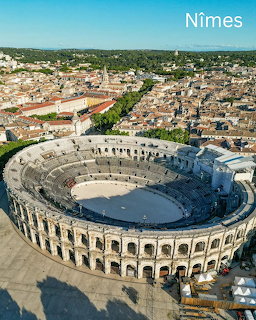 Aerial photo of the Roman amphitheater Arena of Nîmes surrounded by the old town in France
