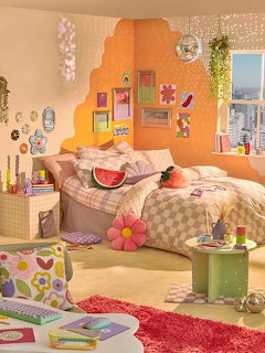 Colorful decorated bedroom with bed, fruit pillows, wall art, and playful accessories
