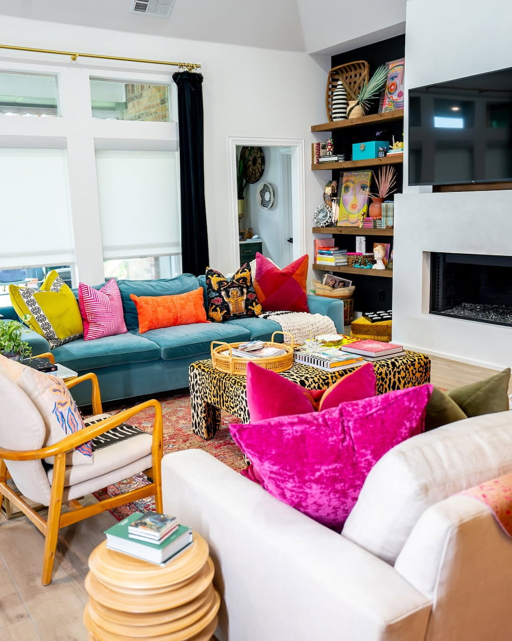 Colorful maximalist living room filled with eclectic furniture, patterns, and decor