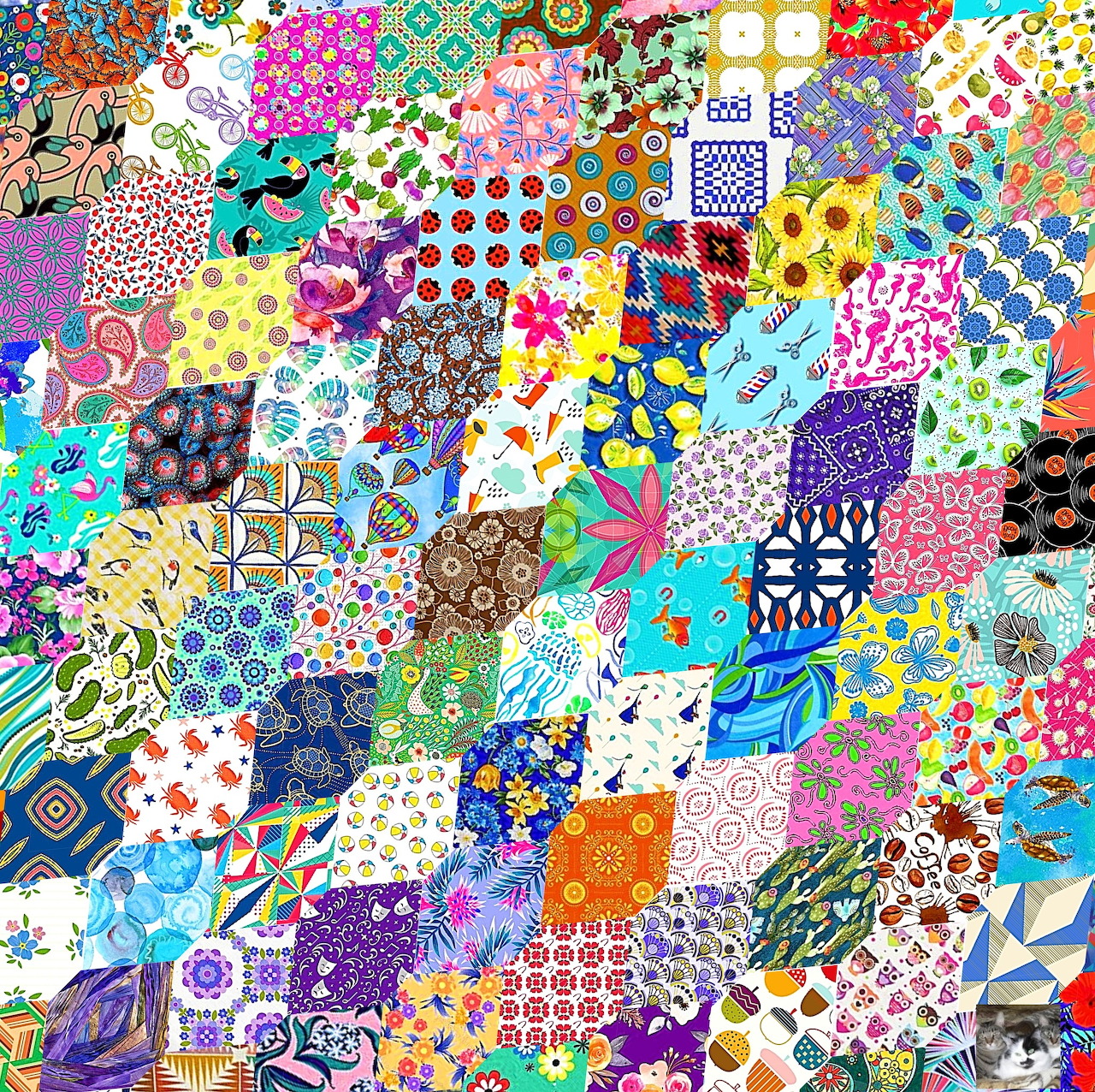 Colorful patchwork quilt with diverse patterns including flowers, dots, geometric shapes, and decorative fabric squares