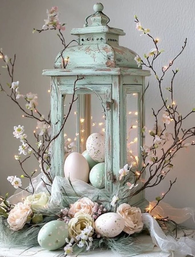 Vintage lantern with Easter eggs and spring flowers in soft pastel colors