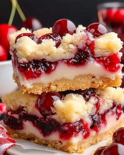Stack of cherry crumble dessert bars with red fruit topping and crumb crust on a white plate