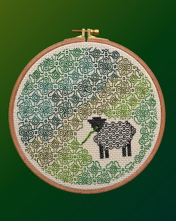 Embroidery hoop with geometric stitching and a black sheep design on green background