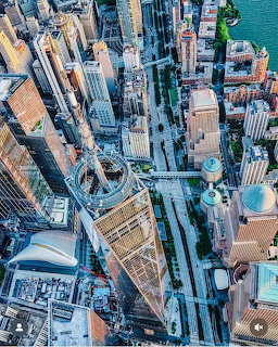 Aerial photograph of urban city center showing tall buildings, streets, and rooftops from directly above
