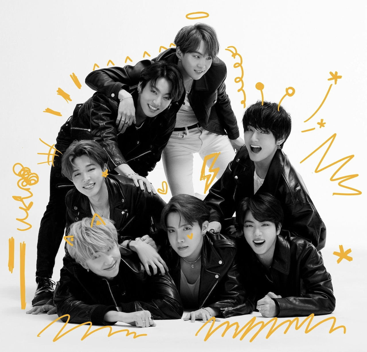 Seven BTS members posing together in black outfits with yellow doodles on a white background