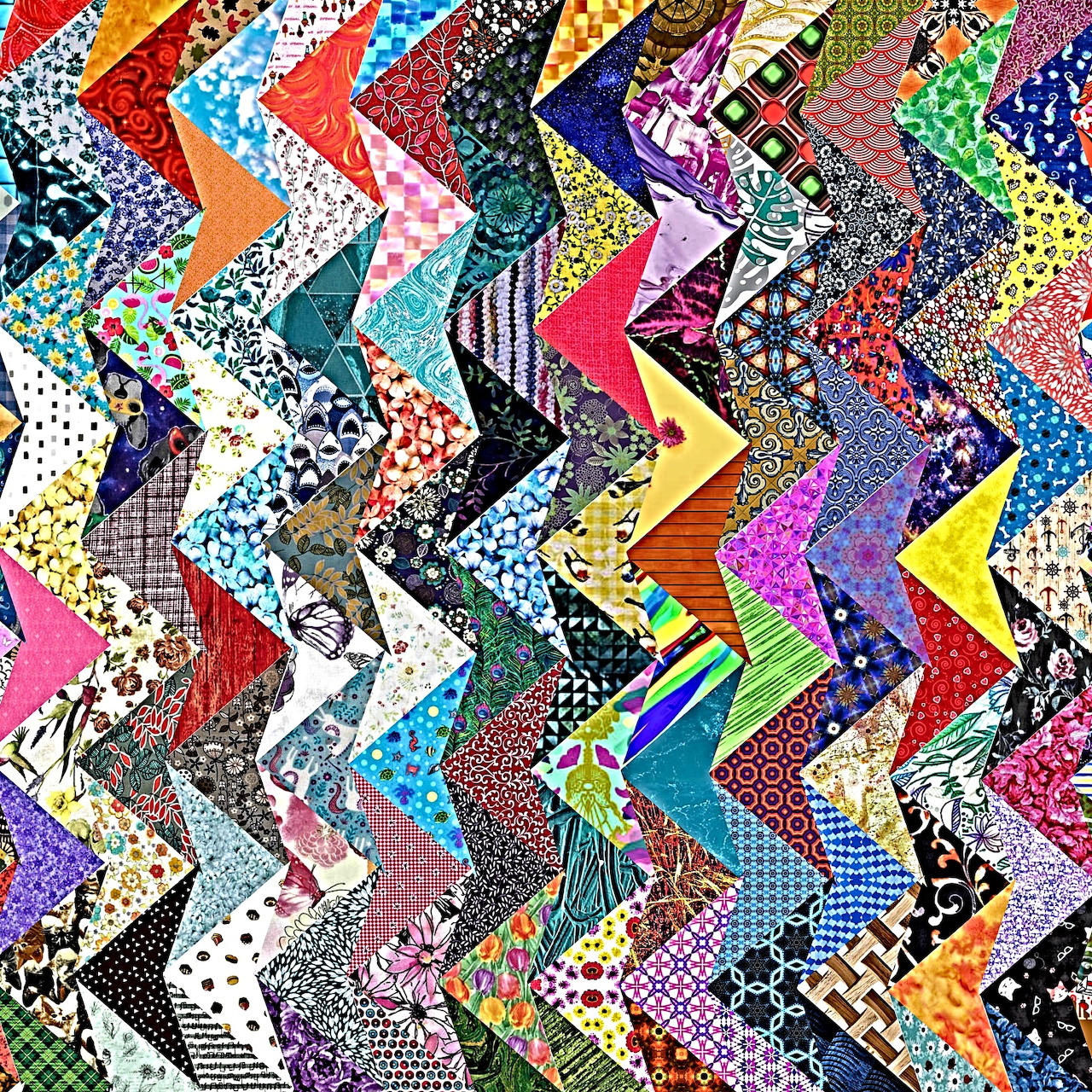 Colorful zigzag patchwork quilt with diverse fabric patterns in chevron arrangement