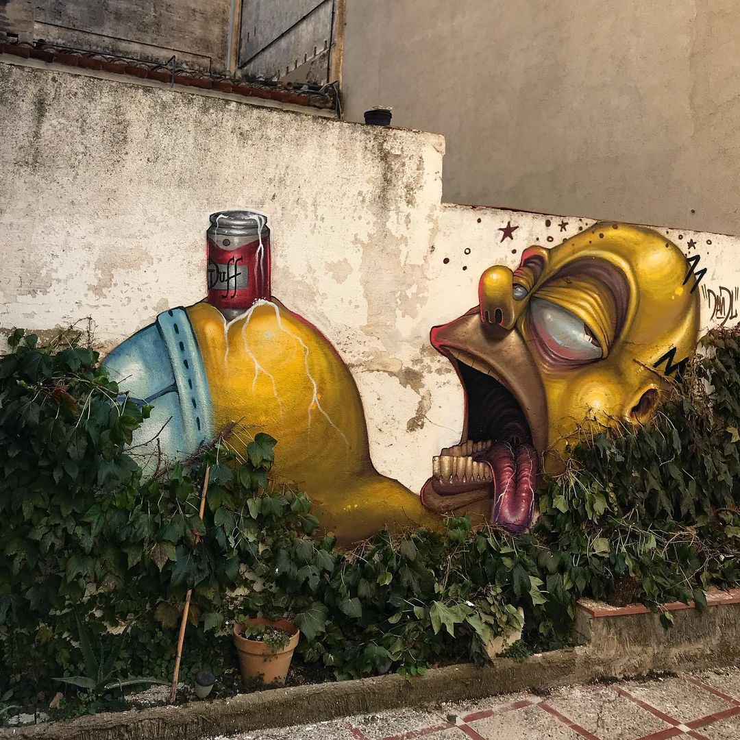 Colorful Minion character street art mural on weathered wall with plants