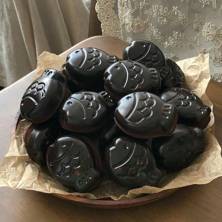 Fish-shaped chocolate candies in a wicker basket lined with parchment paper