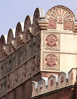 Ornate brick facade of Kazinczy Street Synagogue with geometric decorative patterns and architectural detailing