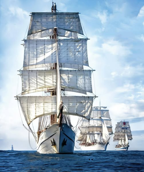 Sailing ship with white sails on open ocean