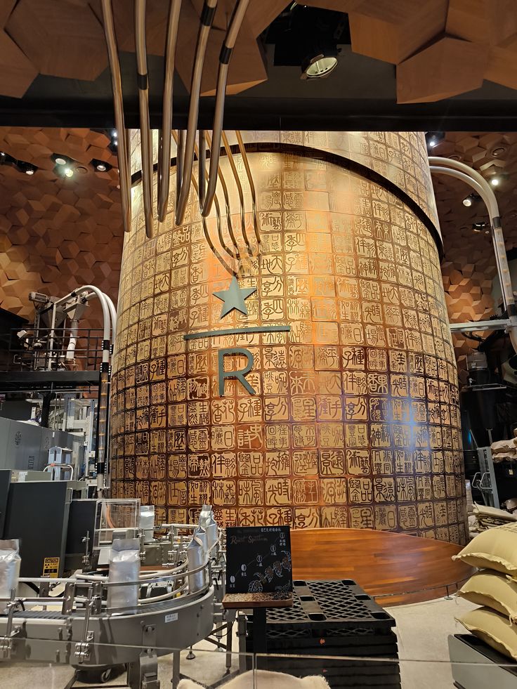 Large ornate copper roasting cask with engraved tiles and copper pipes inside Starbucks Reserve Roastery Shanghai