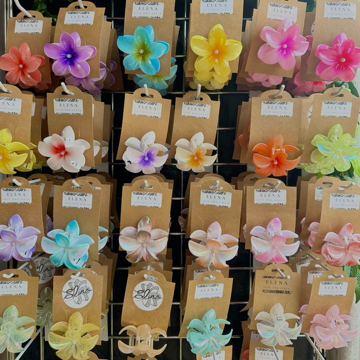 Rows of colorful flower-shaped accessories attached to brown display cards