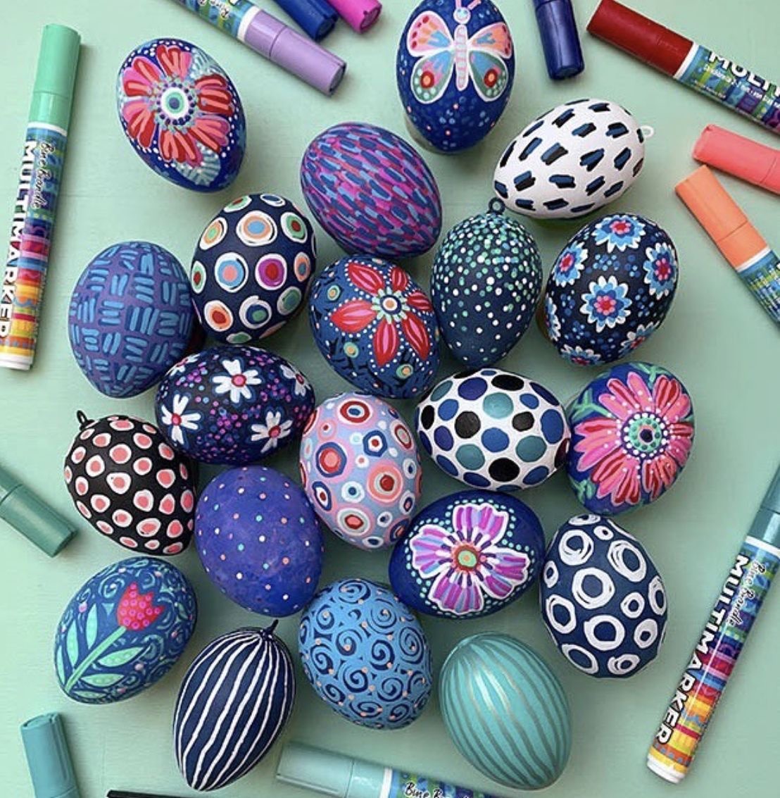 Colorful hand-painted Easter eggs with intricate patterns arranged with paint markers