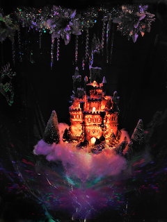 Glowing orange castle surrounded by purple clouds and hanging plants in darkness