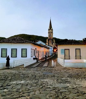 Cobblestone street with colonial houses and a church steeple in Goiás Velho at dusk