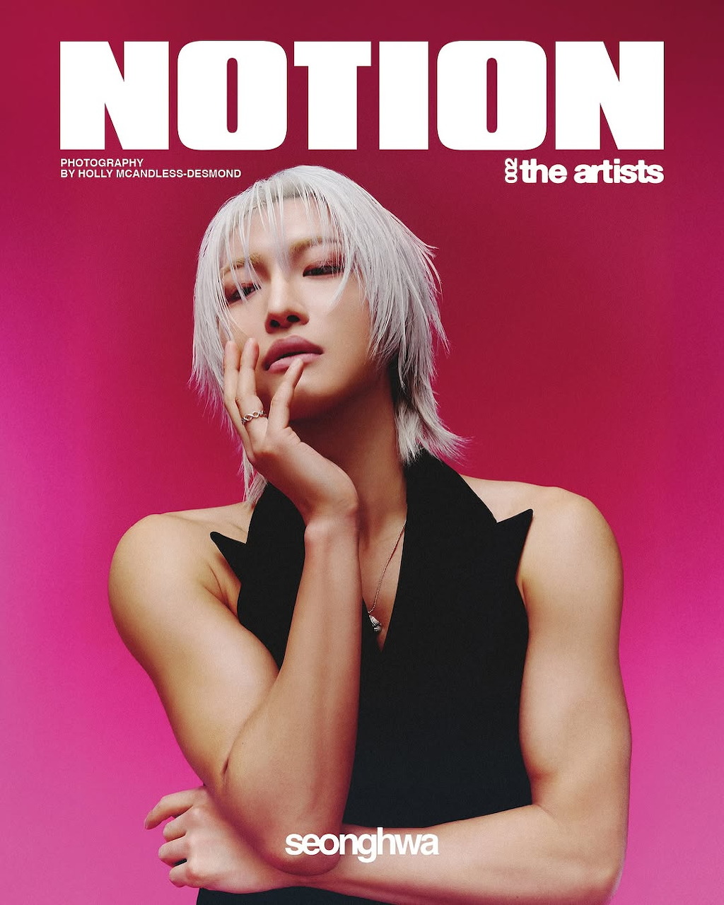 Seonghwa from ATEEZ with platinum blonde hair posing against a hot pink background on a magazine cover