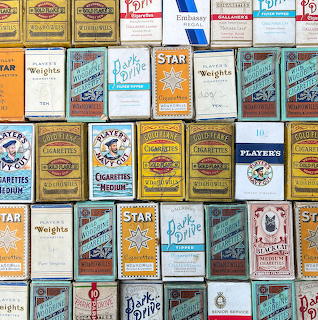 Collage of colorful vintage cigarette packet designs arranged in a grid pattern