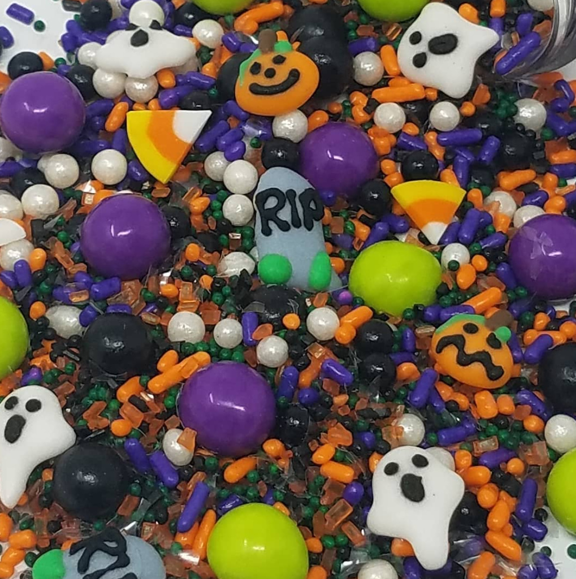 Assorted Halloween candy sprinkles with ghosts, pumpkins, candy corn, and colorful round candies