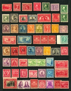 Collage of vintage U.S. postage stamps in various colors arranged on a black background