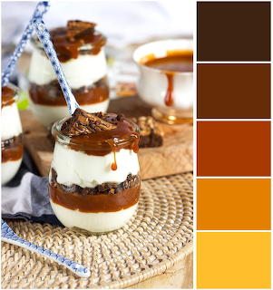 Glass jars of layered salted caramel brownie parfait with caramel sauce and a brown-orange color palette