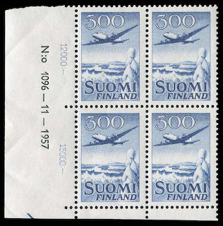 Block of four blue Finnish Finland stamps with airplane design and white paper margin