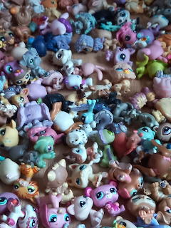 Pile of colorful Littlest Pet Shop animal toy figurines