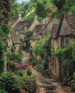 Narrow stone path between old Cotswold stone cottages covered in greenery and flowers