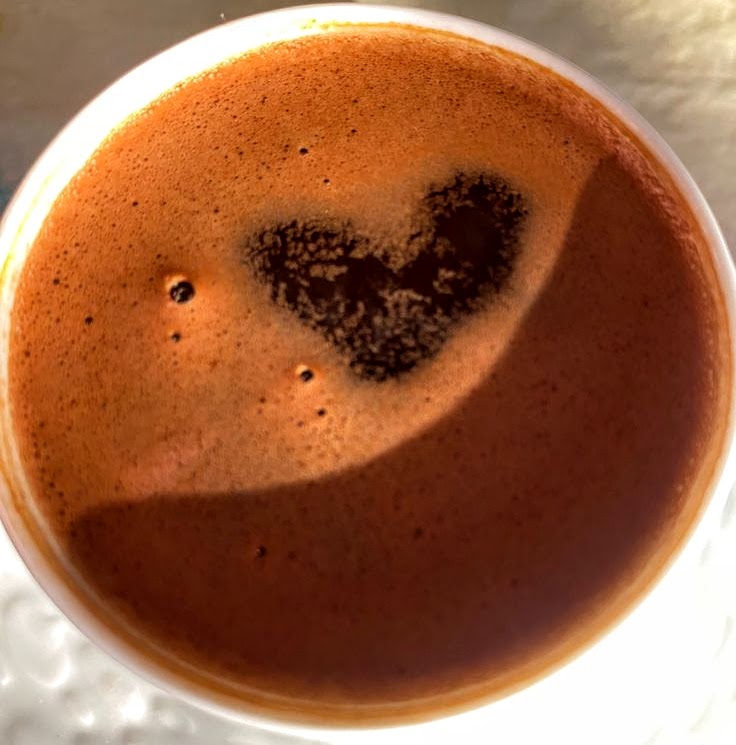 Overhead view of coffee with heart-shaped crema pattern in foam