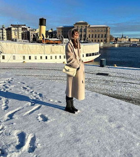 Woman by Snowy Waterfront