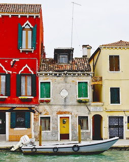 Colorful Venice buildings along canal with moored boat