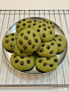 Green matcha cookies with chocolate chips on a cooling rack