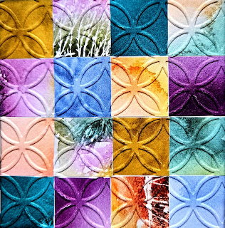 Colorful abstract patchwork of textured square tiles with embossed floral circle patterns