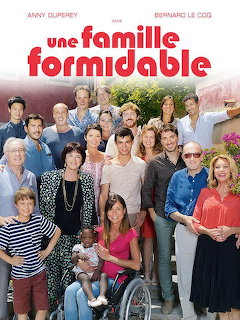 Large group of people posing together outdoors for a family photo, TV show cast