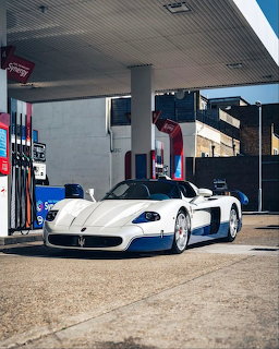White Maserati MC12 supercar at gas station