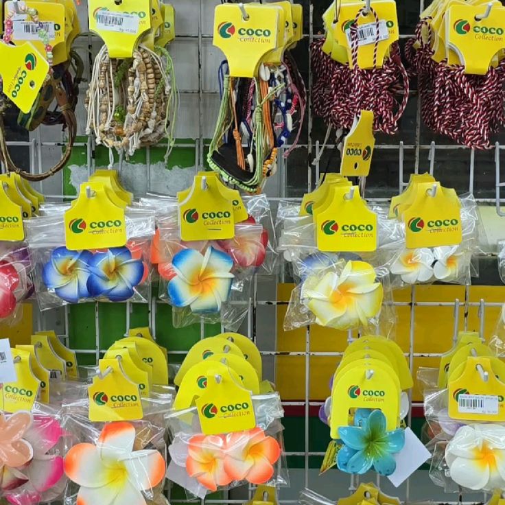 Colorful bead necklaces and tropical flower clips hanging on a display rack