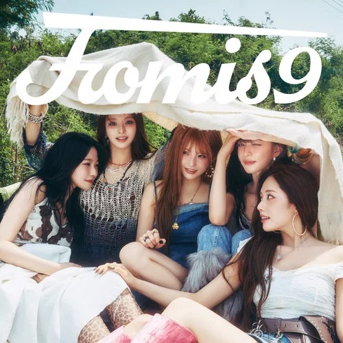 Five women posing outdoors beneath a light fabric banner with fromis9 text