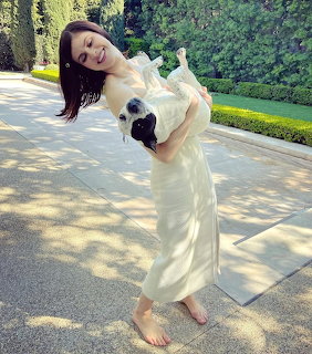 Woman Holding Small Dog Outdoors