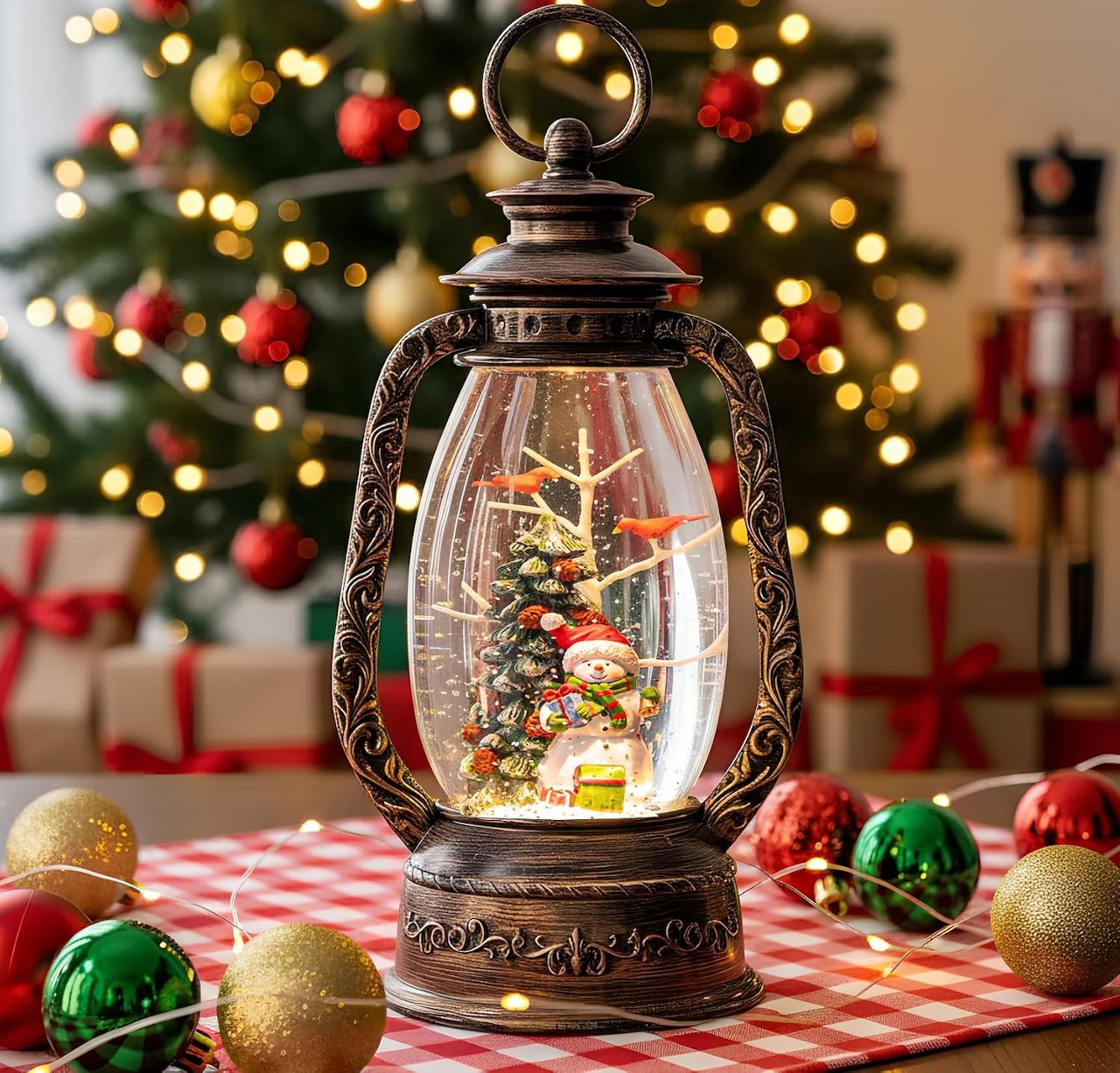 Ornate bronze lantern with miniature Christmas tree scene, red checkered table, colorful ornaments and blurred tree behind