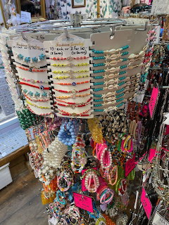 Colorful handmade beaded bracelets and seashells on sand