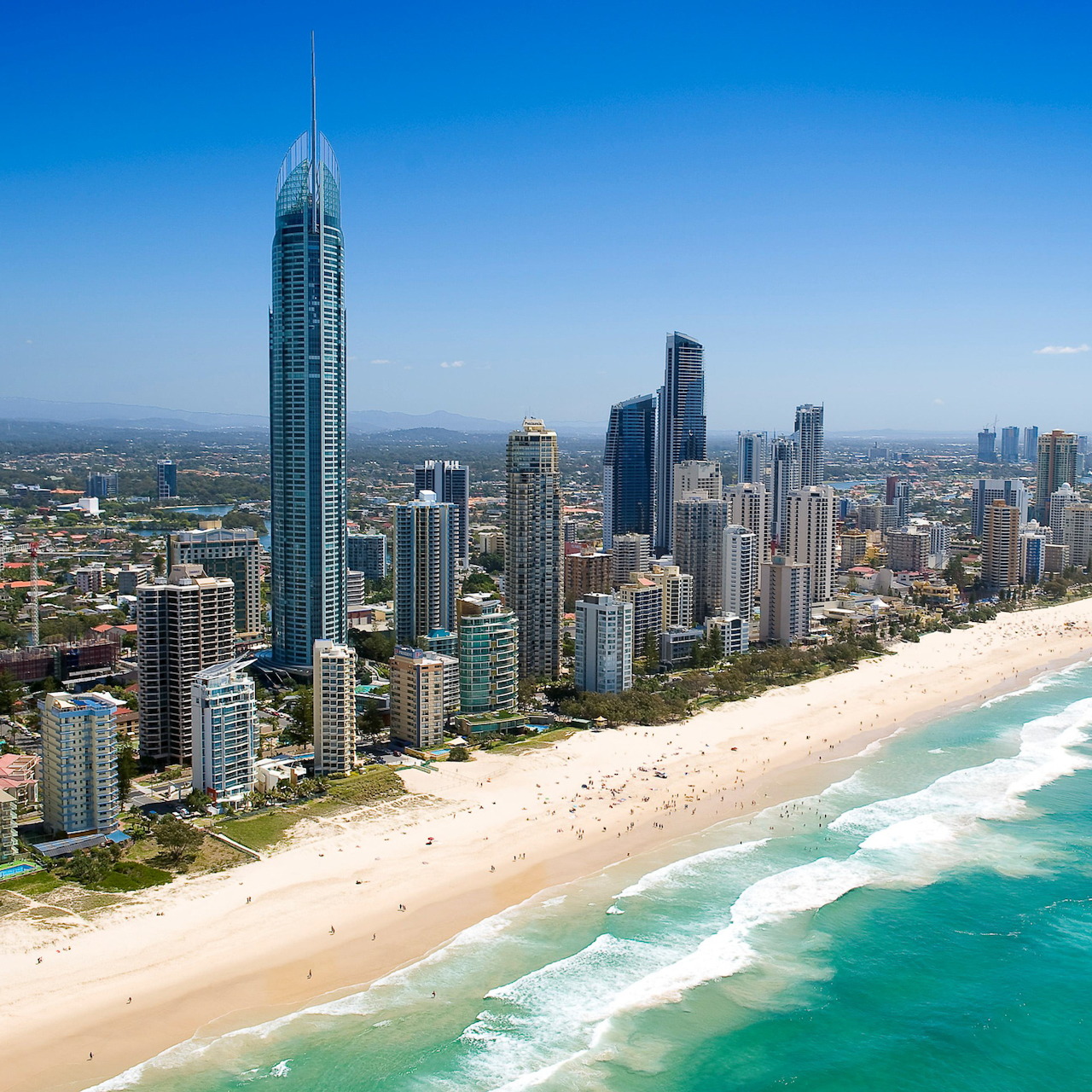 Aerial view of Gold Coast beach with skyscrapers and turquoise ocean waves