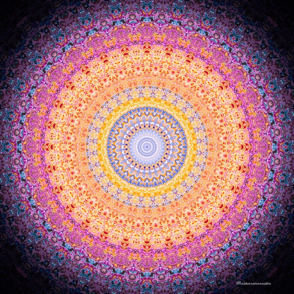 Detailed mandala with concentric circles in orange, pink, and purple hues on black background